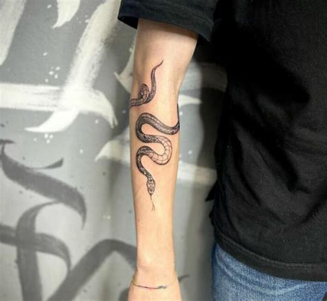 snake wrapping around forearm tattoo